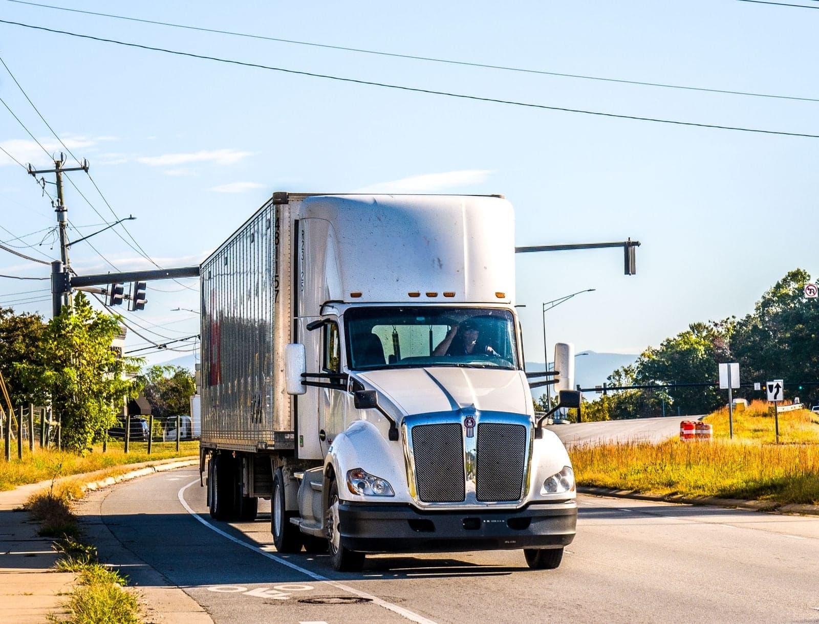 A white semi-truck on the road