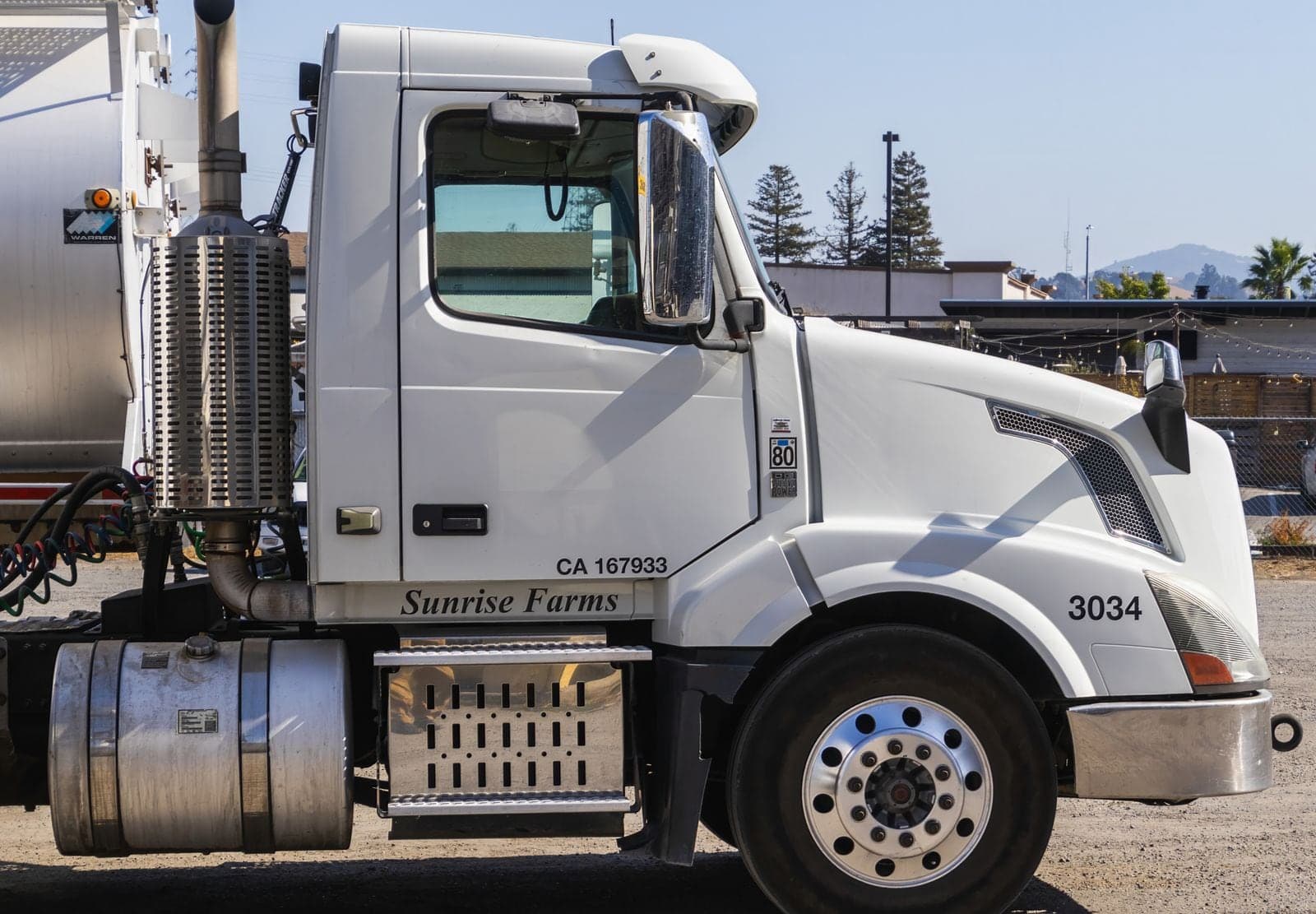 Coiled air lines behind the cab of a white Volvo truck